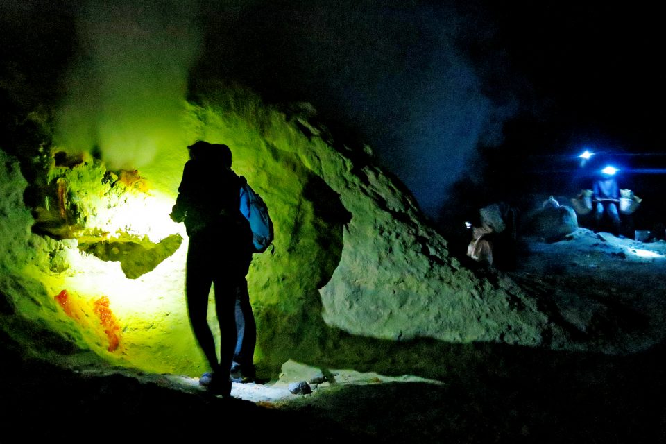 People trekking in the dark with torches