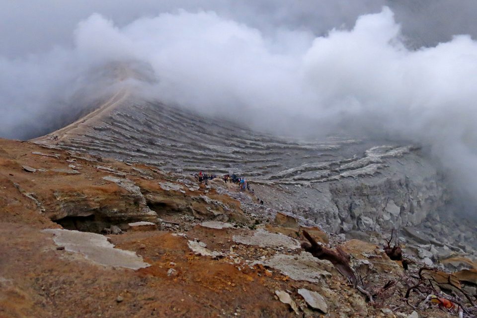 A group of people trekking over the volcano