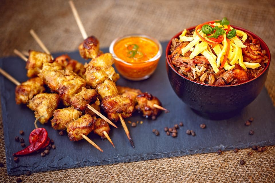 Chicken skewers and seafood on a slate
