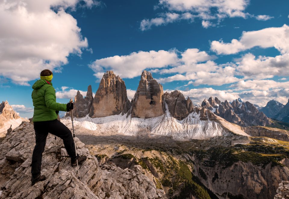 A hiker looking out at rocky mountain peaks