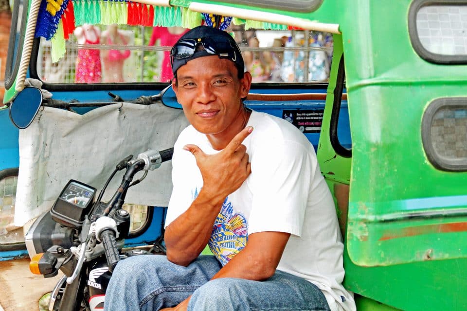 A local man sitting in his tuk tuk